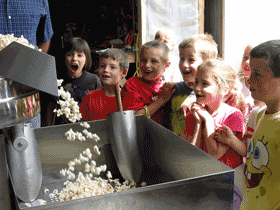 kids enjoying kettle corn at our manufacturing plant